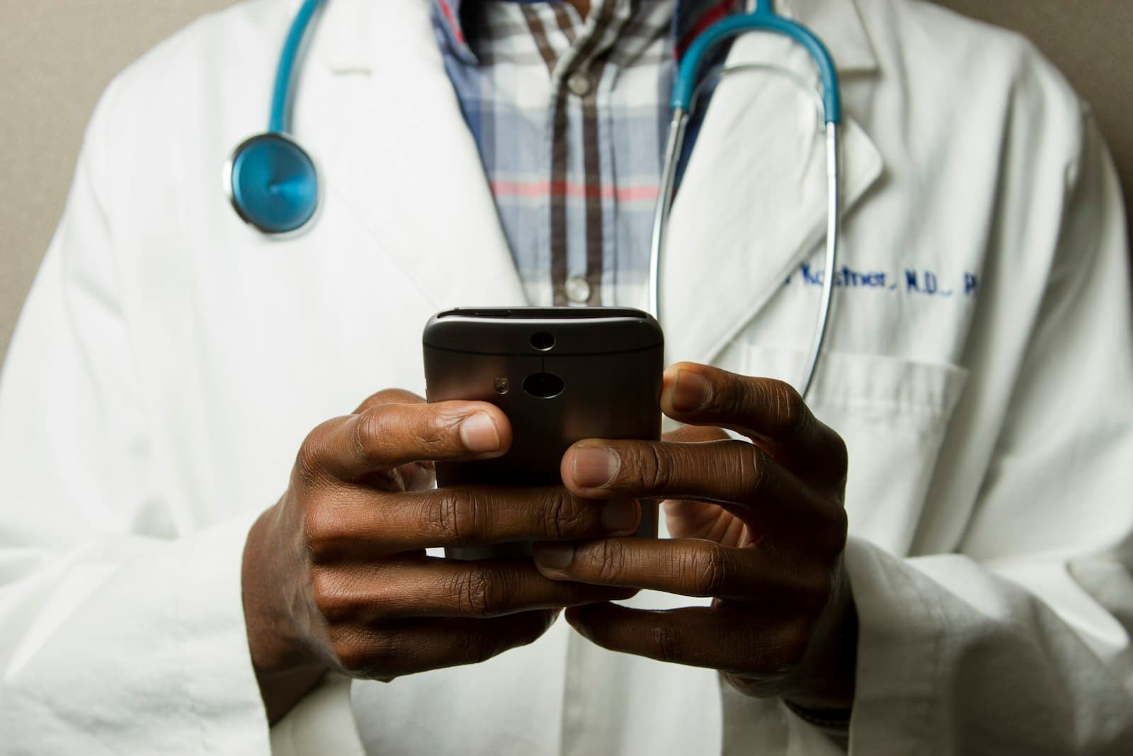 Doctor using a mobile device in a healthcare setting.